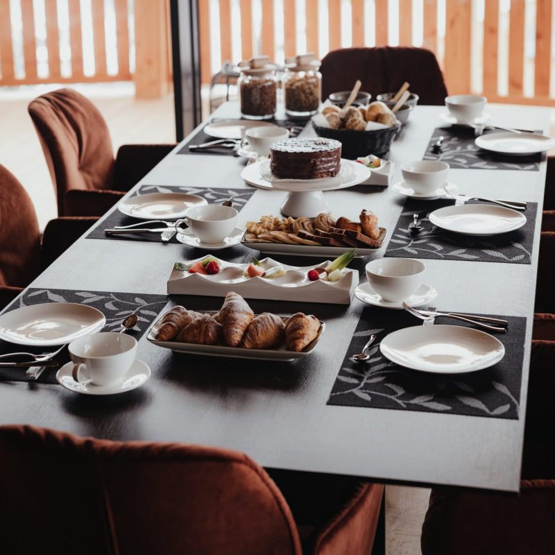 Sala da pranzo all'Chalet Sasslong con tavolo apparecchiato.